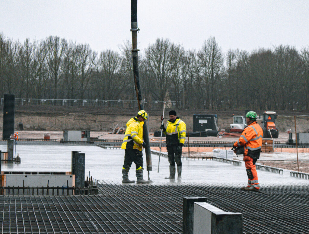 Construction workers pouring concrete