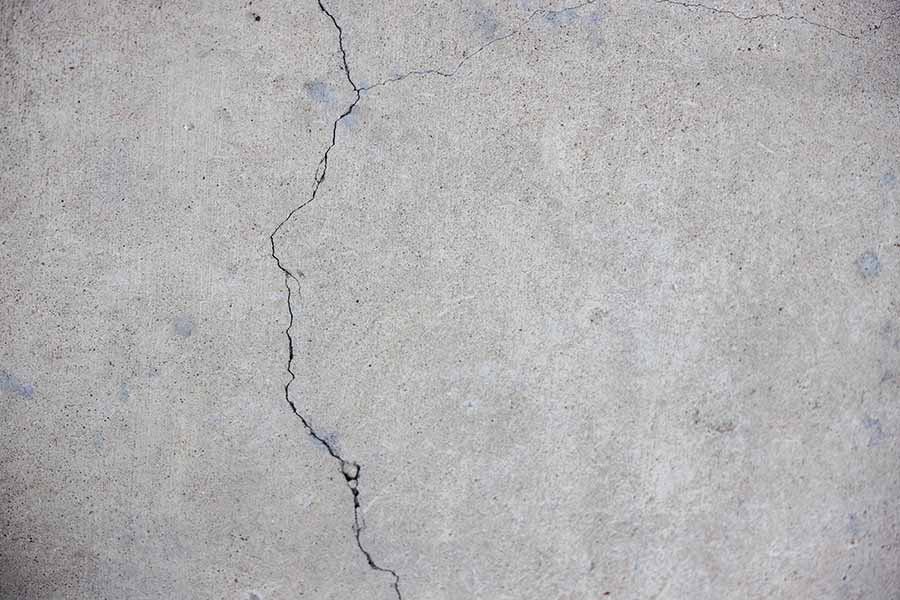 Cracked grey concrete wall.